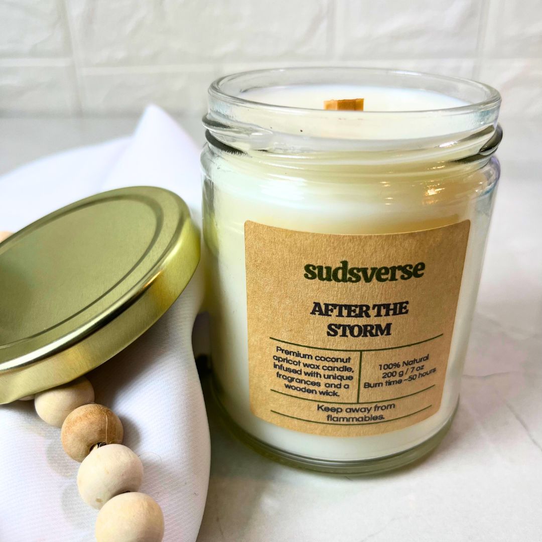 After the storm coconut apricot wax wooden wick candle with the lid on a satin background showing the detail of the candle jar.