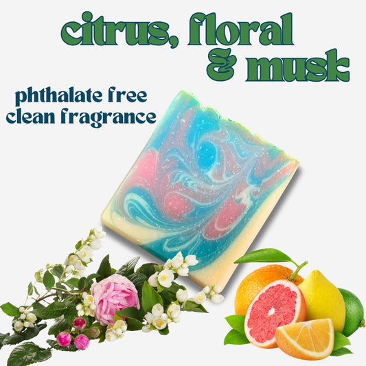 Experience the vibrant scent of Petal Pop Natural Soap with this citrus, floral, and musk inspiration image. Featuring fresh roses, jasmine, and citrus fruits, this phthalate-free, clean fragrance soap nourishes all skin types. Shop this eco-friendly, handmade bar for a sustainable beauty routine.