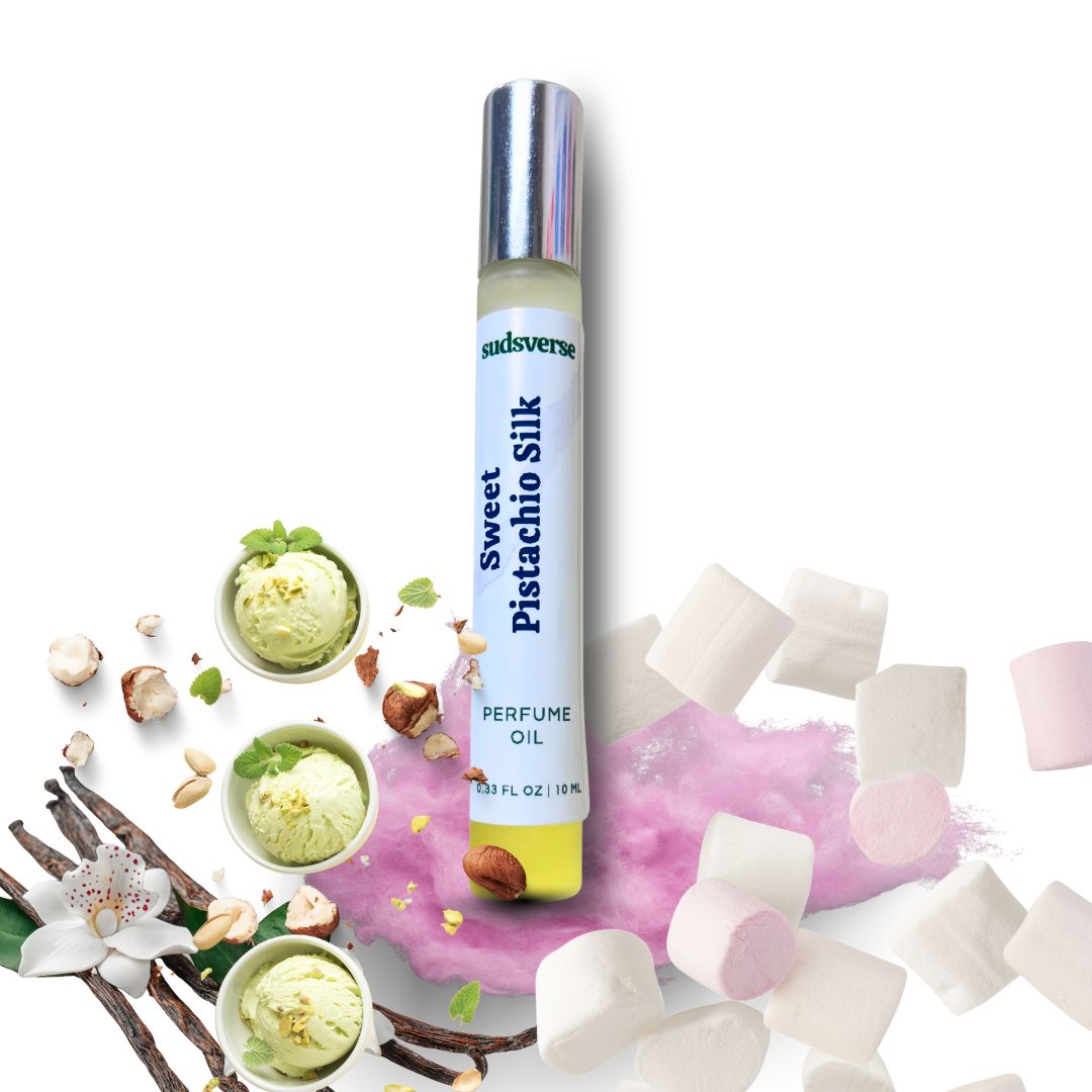 Perfume oil bottle labeled 'Sweet Pistachio Silk' surrounded by pistachios, flowers, and marshmallows on a white background.