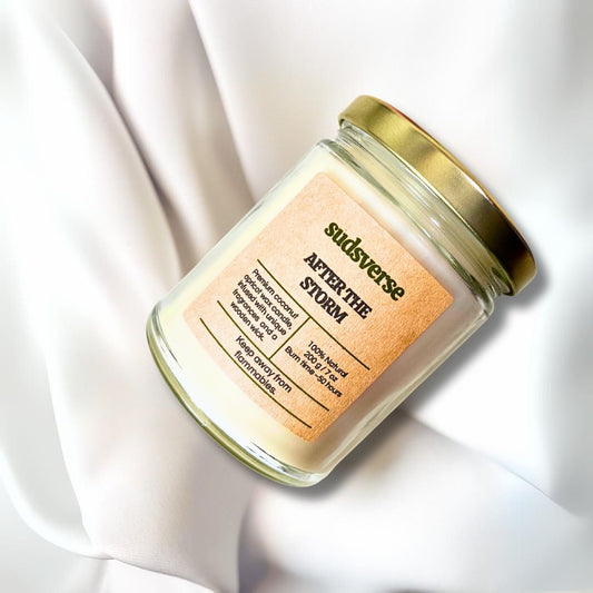 A jar of after the storm wooden wick premium coconut apricot wax candle on a satin fabric background.